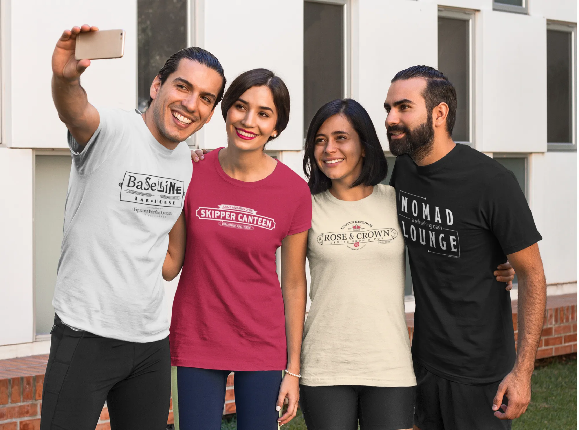 two men and two women taking a selfie with Disney shirts on