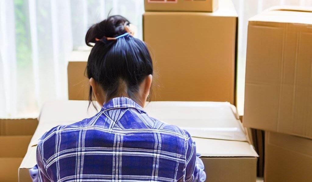Young woman packing boxes